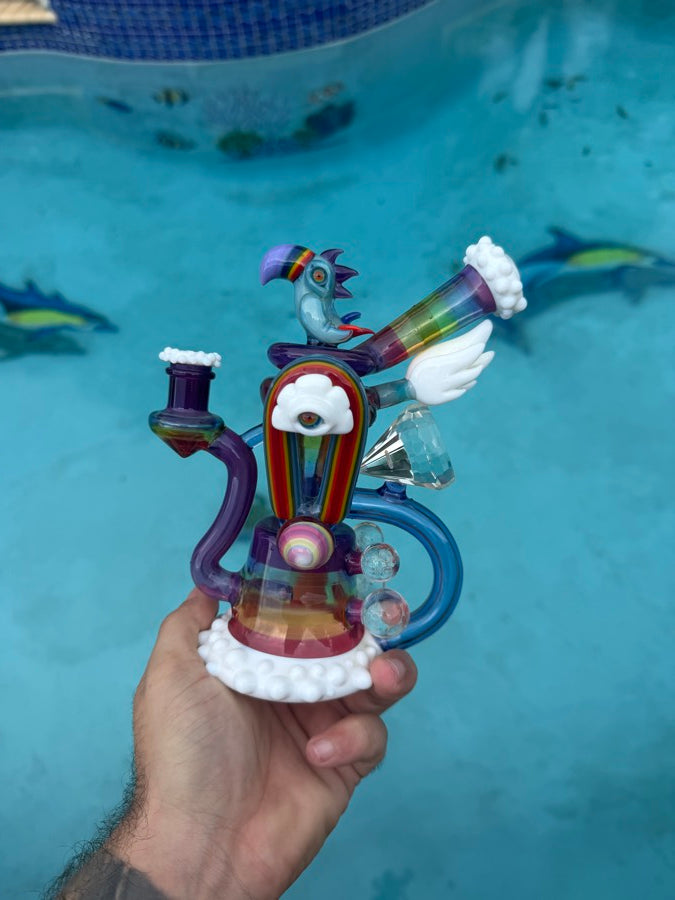 Recycler with a bird top and cloud-and-eye front with faceted crystal accents, poolside in Miami